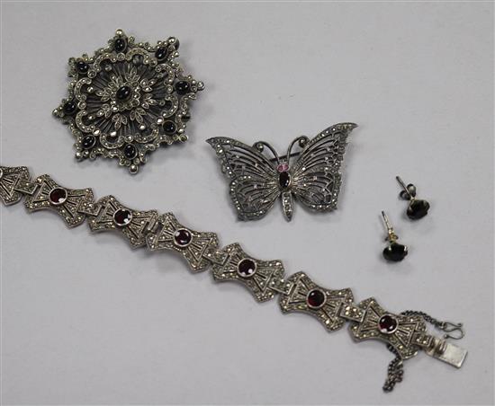 A silver marcasite and garnet set bracelet, two silver and marcasite brooches and a pair of earrings.